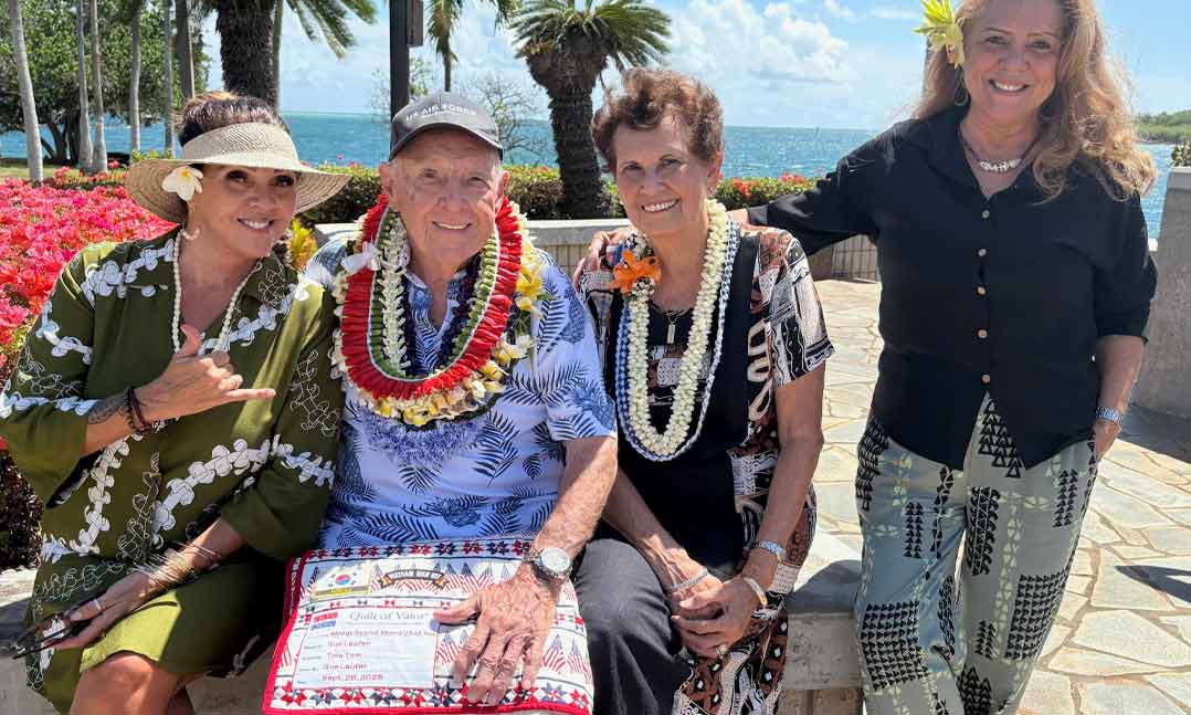 Past-VFW Post 970 Commander Ralph Moore and his wife celebrate with his daughters after receiving a Quilt of Valor at the Joint Reserve Base Pearl Harbor-Hickam