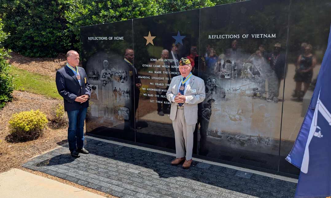 VFW Commander-in-Chief Al Lipphardt, along with Col. Richard Caravana, hold up colors of the 196th Infantry Brigade