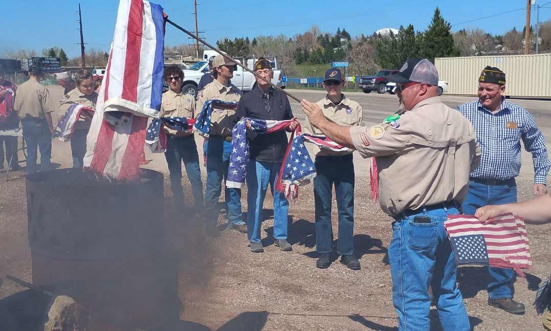 Members of VFW Post 7756 in Gillette, Wyo., teach Boy Scouts how to properly dispose of U.S. flags 