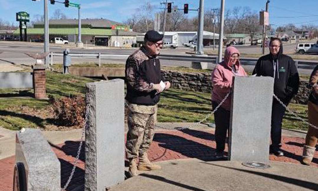 VFW Post 1828 Junior Vice Commander David Scott Buennemeyer, left, speaks at the Veterans Memorial in West Plains, Mo