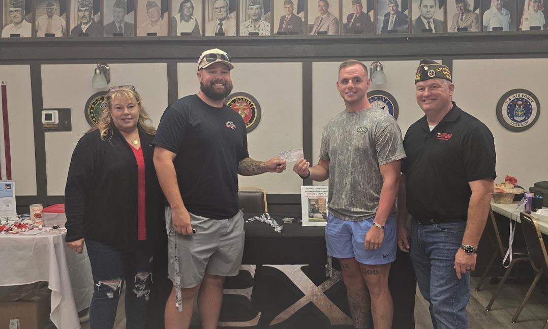 The CEO of Excerebus, pictured center-left, hands a check to the 1st place winning team, nicknamed “Why is the Sky Blue.” 