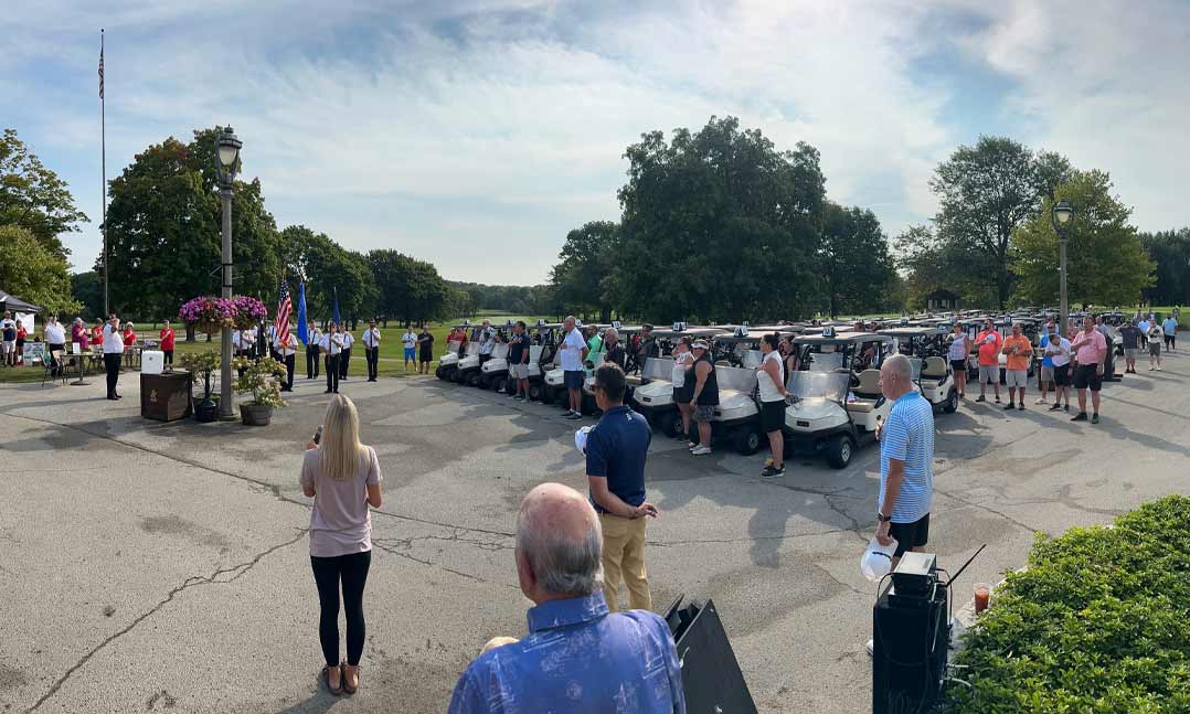 Members of VFW Post 9202 and its Auxiliary, along with other golfers, stand for the national anthem at last year’s tournament in Brown Deer Park in Milwaukee, Wisconsin