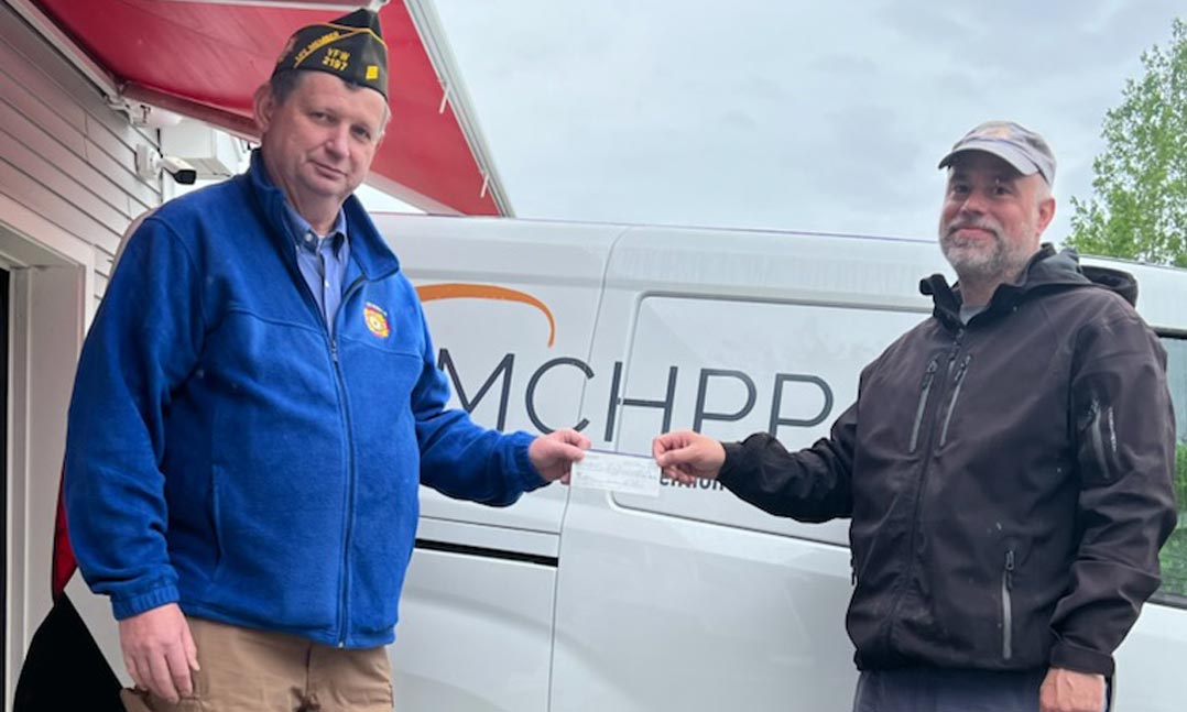 VFW Post 2197 Quartermaster Jonathan “Dale” Brown, left, issues a check of $1,475 to the Mid-Coast Hunger Prevention Program