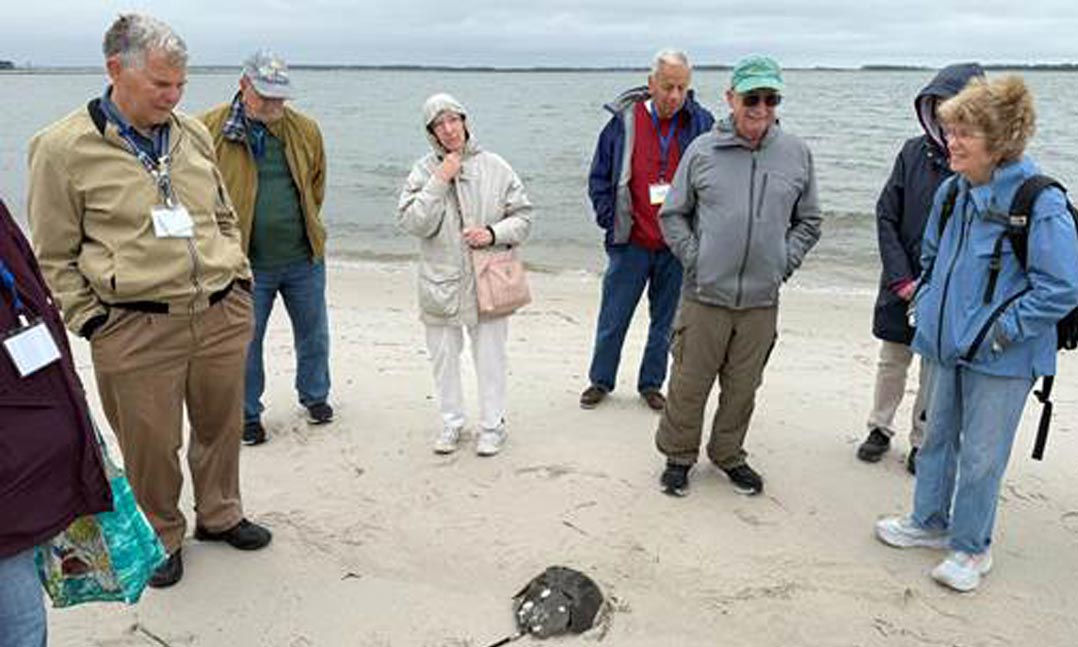A Navy veteran John Bartley teaches on the beach