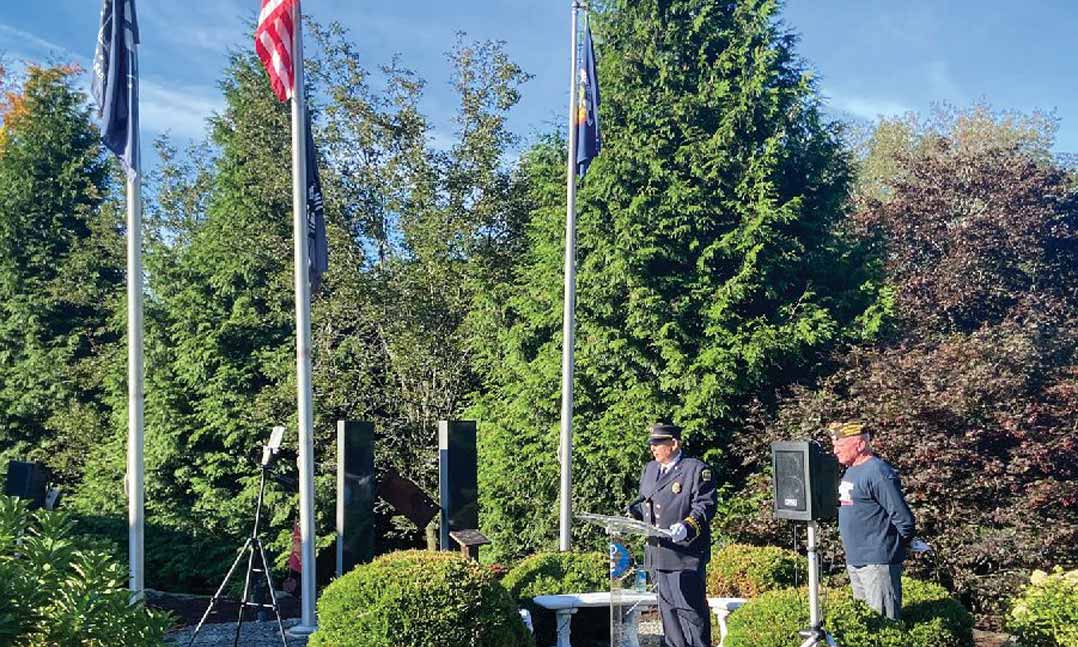 Brewster-Southeast Joint Fire District Commissioner Jerry Schramek, left, gives a commemorative speech