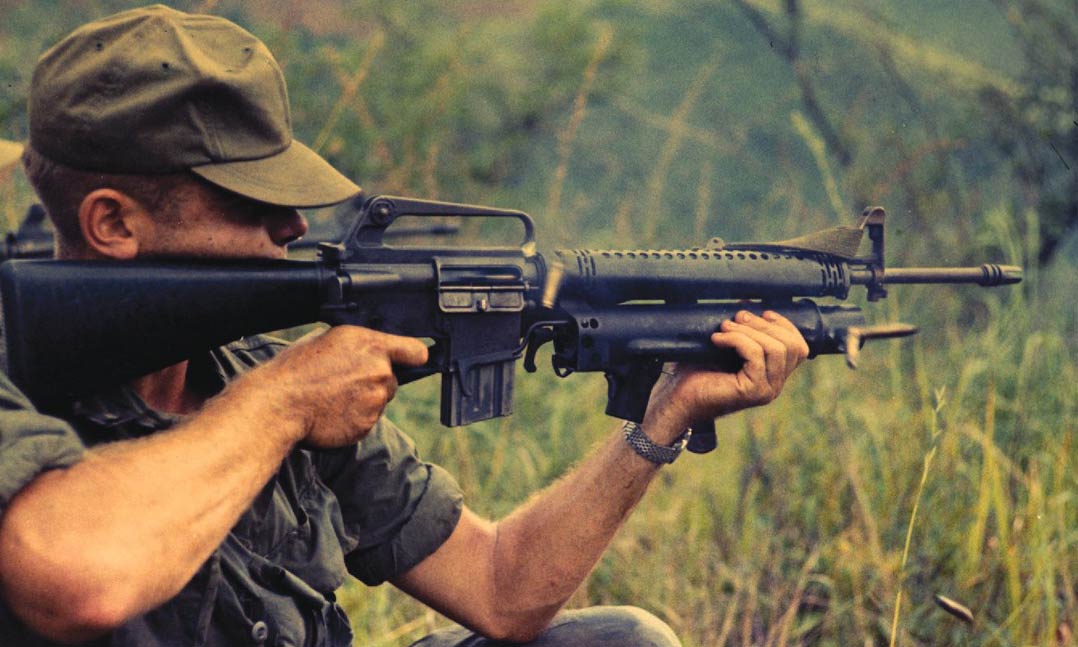 Army Spec. 4 Henry Willey “recons by fire” using his M-148 XM rifle